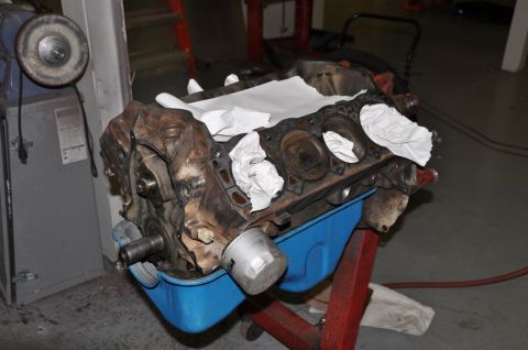 1996 Ford Bronco - Disassembled engine block sits in a workshop, awaiting rebuild.