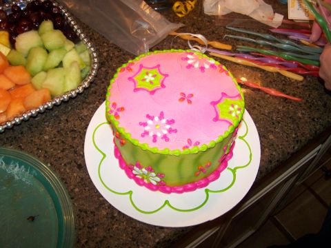1978 Ford Bronco - A festive spread a decorated cake and a fruit platter, ready for a celebration.