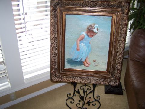 1978 Ford Bronco - A framed painting depicts a young girl in a blue dress observing a starfish on a sandy beach.