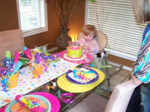 1978 Ford Bronco - A young child sits at a table with a birthday cake and party favors, ready to celebrate.
