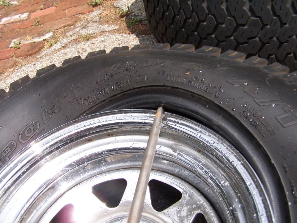 Close-up of a tire on a chrome rim. Tire has text that says "Made in U.S.A."