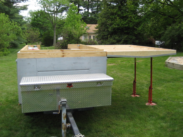 Homebuilt utility trailer with wood floor framing and diamond-plate box on lawn