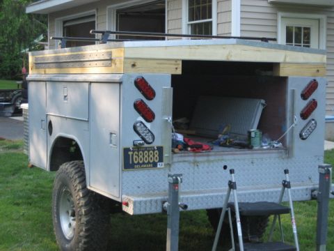 1996 Ford Bronco - This utility truck features a custom wooden rack over its toolbox bed, with a Delaware license plate visible.