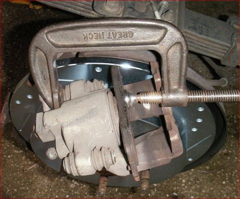 2007 Ford Mustang - A C-clamp is used to compress a brake caliper during a brake job.