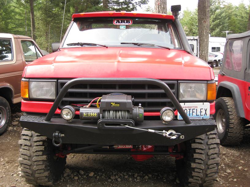 Front of red lifted Ford truck with ARB bar and winch