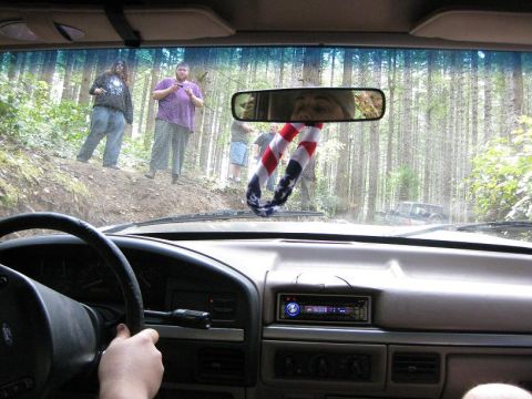 1992 Ford Bronco - Driving through a wooded area with friends watching from the side of the road.
