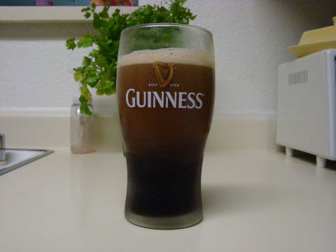 1989 Ford Bronco - A glass of dark Guinness beer sits on a countertop next to a small plant and a white appliance.