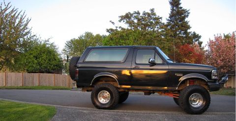 1992 Ford Bronco - This lifted 1992 Ford Bronco is shown from the side, a spare tire mounted on the rear.
