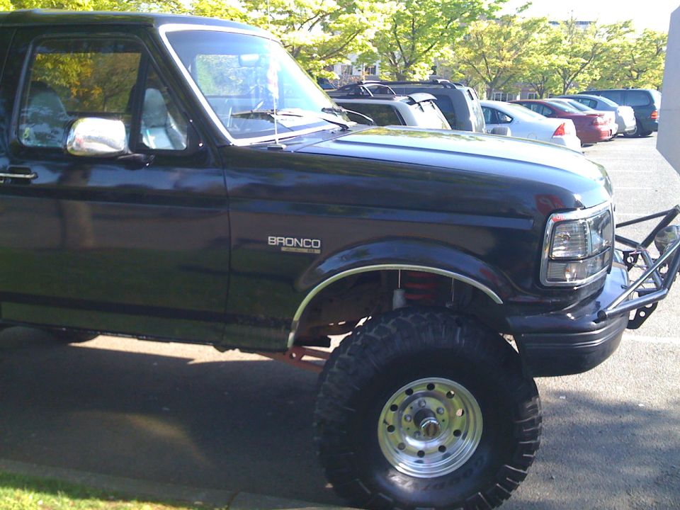 Black 1992 Ford Bronco with custom front bumper and lifted suspension