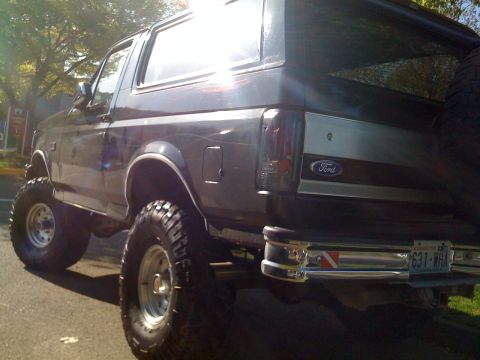 1992 Ford Bronco - This lifted 1992 Ford Bronco has a spare tire mounted on the back and a chrome bumper.