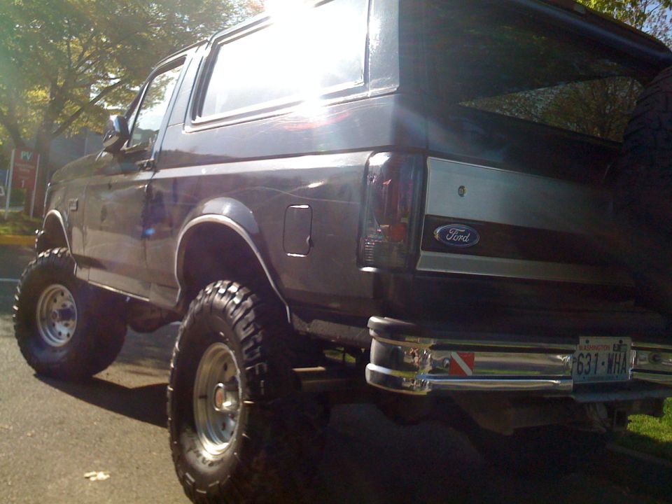 Lifted 1992 Ford Bronco rear view, showing off its big tires and chrome bumper