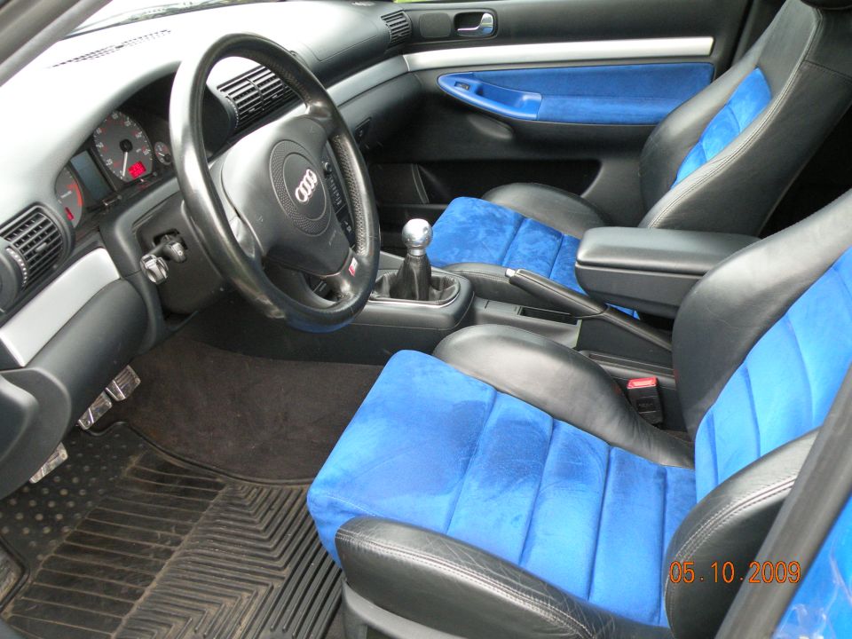 Audi interior with black-and-blue sport seats and manual shifter