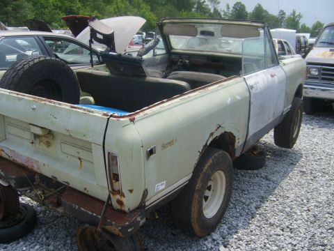 1994 Ford Bronco - Junkyard International Scout II convertible with significant rust and body damage.