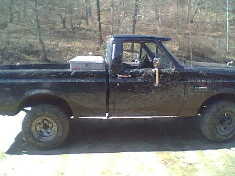 1995 Ford F-150 - This black 1995 Ford F-150 pickup truck is shown from the side, a toolbox mounted in the bed.