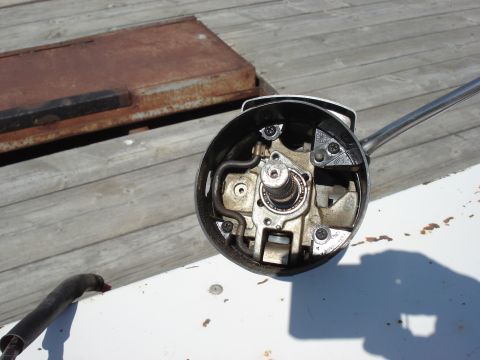 1979 Ford Bronco - Close-up of a disassembled steering column assembly with visible internal components and a chrome lever.