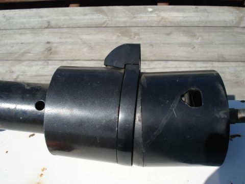1979 Ford Bronco - Close-up of a black steering column tilt mechanism, showing the lever and housing.