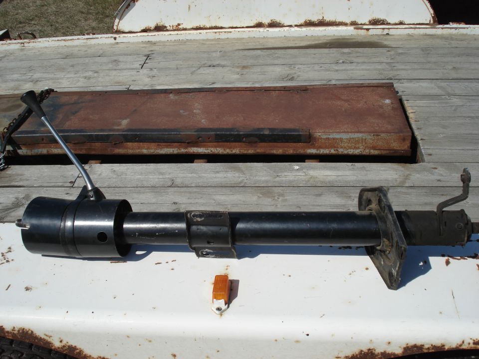 Black steering column with a lever on a wooden trailer bed