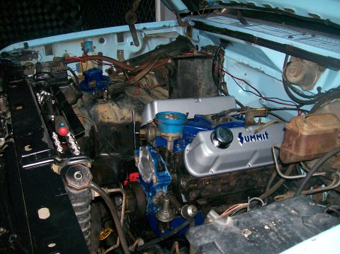 1982 Ford Bronco - The engine bay shows a blue engine with silver Summit valve covers, suggesting a modified or swapped engine.