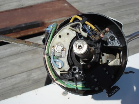 1979 Ford Bronco - Close-up of a vehicle's steering column tilt mechanism, showing internal wiring and electrical components.