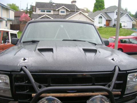 1996 Ford Bronco - Front view of a black 1996 Ford Bronco, a custom hood and bull bar.