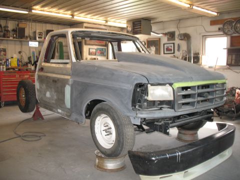 1994 Ford F-150 - A partially disassembled 1992 Ford F-150 truck is undergoing repairs in a workshop setting that appears to be a workshop.