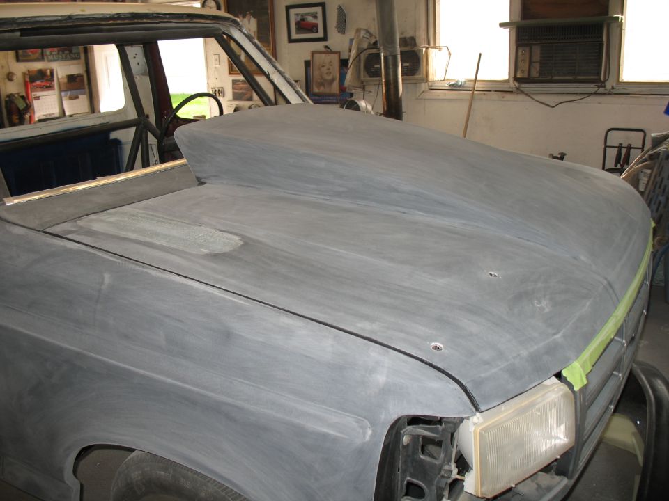 Gray truck with custom hood scoop, front end visible