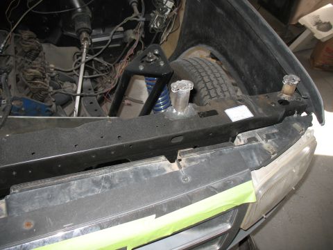 1994 Ford F-150 - Front end of a 1994 Ford F-150 undergoing repairs, with engine and suspension components visible.