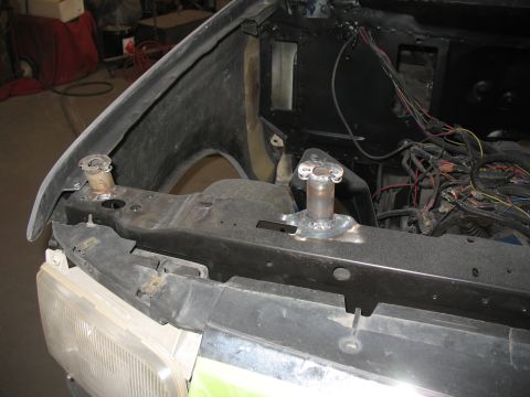 1994 Ford F-150 - The front end of a vehicle is shown with exposed wiring and parts, indicating it is in a state of repair or modification.