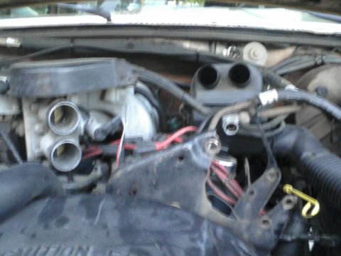 1986 Ford Bronco - Close-up view of the engine compartment, showing various mechanical components and wiring.