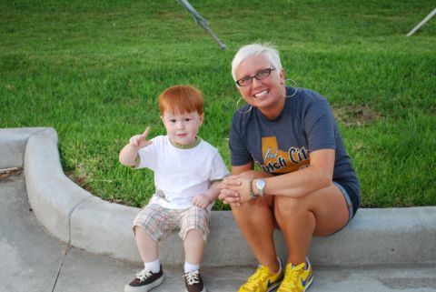2008 Jeep Wrangler - A woman and a young boy pose for a photo while sitting on a curb.
