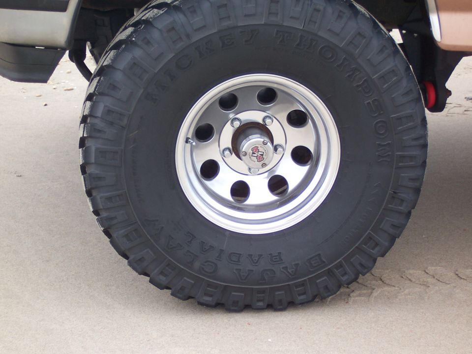 Mickey Thompson Baja Claw tire on polished aluminum wheel with locking hub on a lifted truck