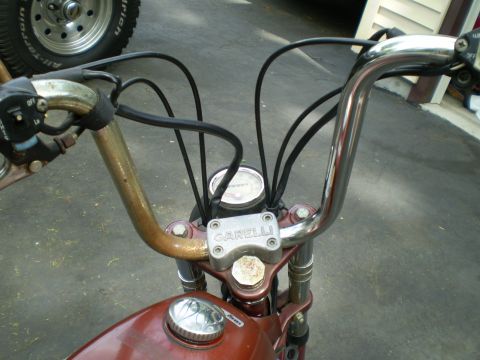 1981 Garelli Rally Sport - The handlebars and front section of a vintage Garelli moped are shown, with a speedometer and fuel cap visible.