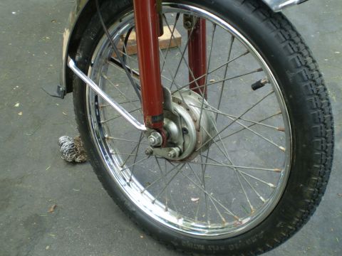 1981 Garelli Rally Sport - Close-up of a motorcycle's front wheel assembly, showing the tire, spokes, and brake mechanism.