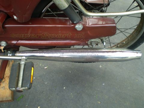 1981 Garelli Rally Sport - Close-up of a moped's side panel showing 'SuperSport XL' branding and a chrome exhaust pipe.