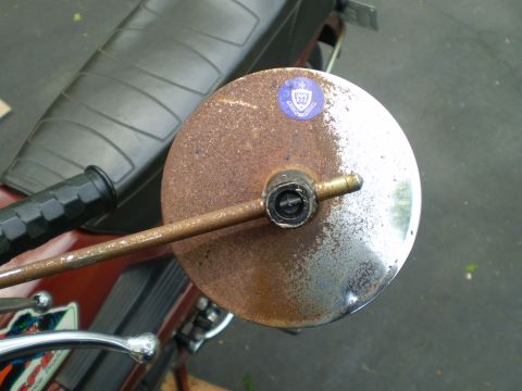 1981 Garelli Rally Sport - A close-up of a heavily rusted motorcycle mirror, showing its circular face and mounting hardware.
