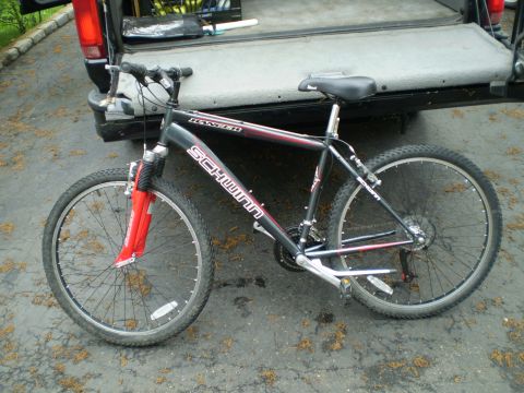 1981 Garelli Rally Sport - A black Schwinn Ranger bicycle with red accents is parked next to the open tailgate of a pickup truck.