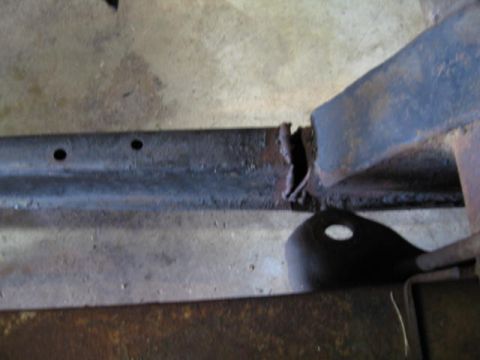 1963 Ford Galaxie - Close-up of a damaged and rusted vehicle frame section.