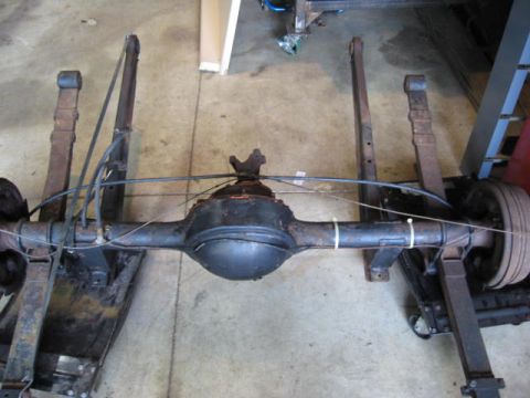 1963 Ford Galaxie - A rear axle assembly with leaf springs and a brake drum is shown, likely for a restoration project.