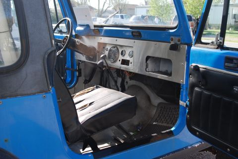 1981 Jeep CJ7 - Interior view of a blue Jeep CJ7, showing the dashboard, steering wheel, and driver's seat.