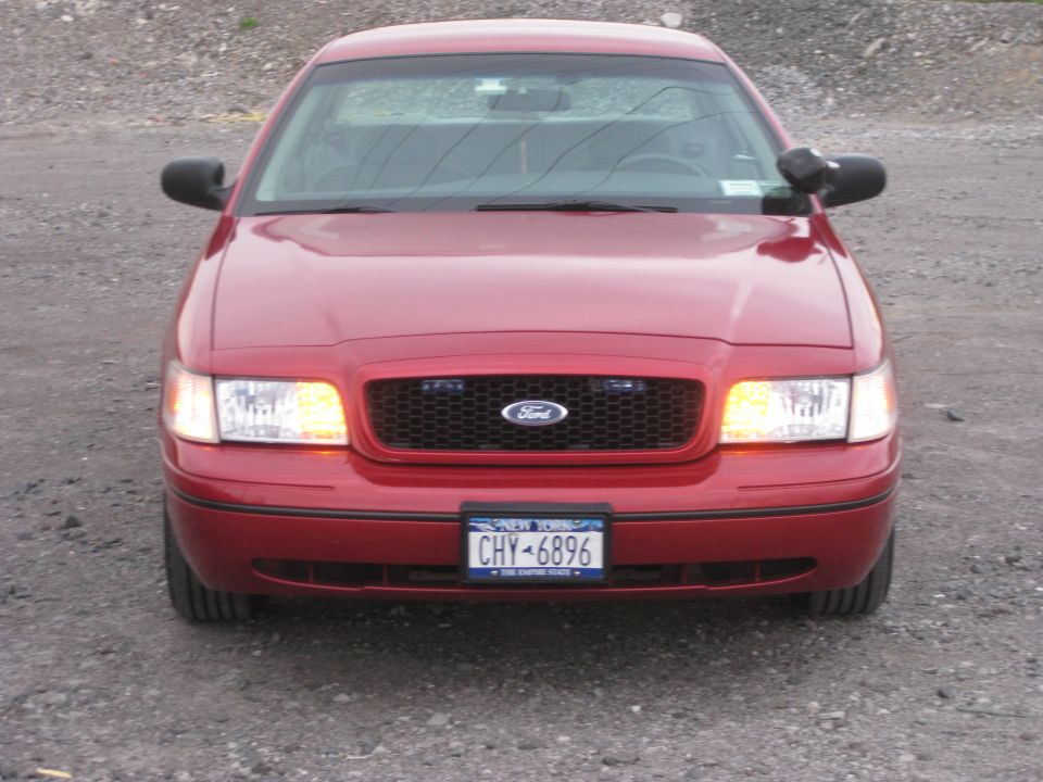 Front view of a red 2000 Ford Crown Victoria police car with New York plates CHY-6896