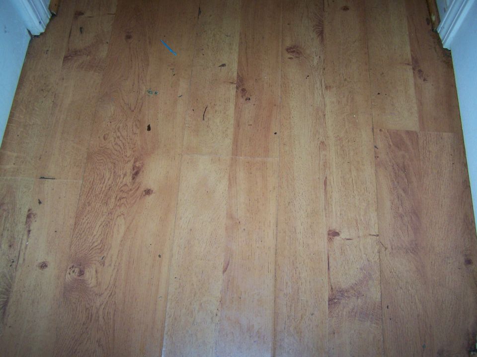 Wood-look flooring with visible wear and tear