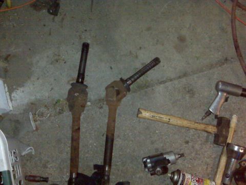 1995 Ford Bronco - Tools and vehicle parts are laid out on the ground, suggesting a repair or maintenance session.