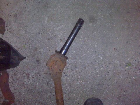 1995 Ford Bronco - A close-up view of a driveshaft component, showing its splined end and a rusty universal joint.