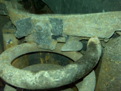 1995 Ford Bronco - Close-up view of heavily corroded vehicle suspension parts.