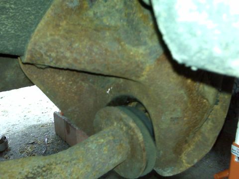 1995 Ford Bronco - Close-up of a heavily rusted vehicle suspension part showing a crack.