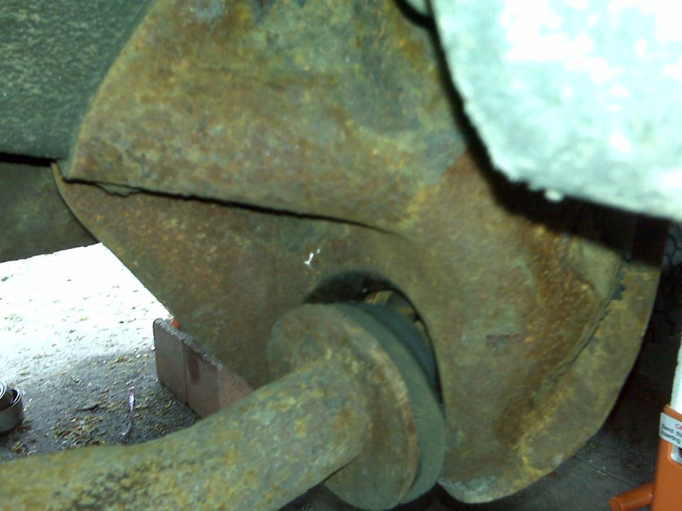 rusted suspension component with visible crack
