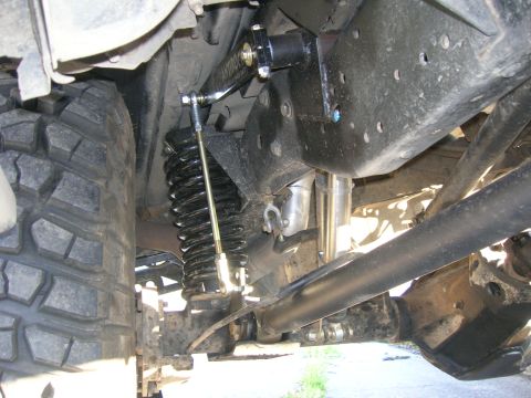 1996 Ford Bronco - Detail of the rear suspension system, showing the coil spring and shock absorber assembly.