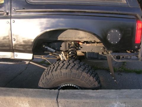 1996 Ford Bronco - Close-up of the rear suspension and tire on a 1996 Ford Bronco, modified with an Antirock sway bar.