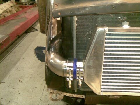 1969 MINI Cooper - Close-up view of intercooler piping and radiator assembly, likely part of a custom engine modification.