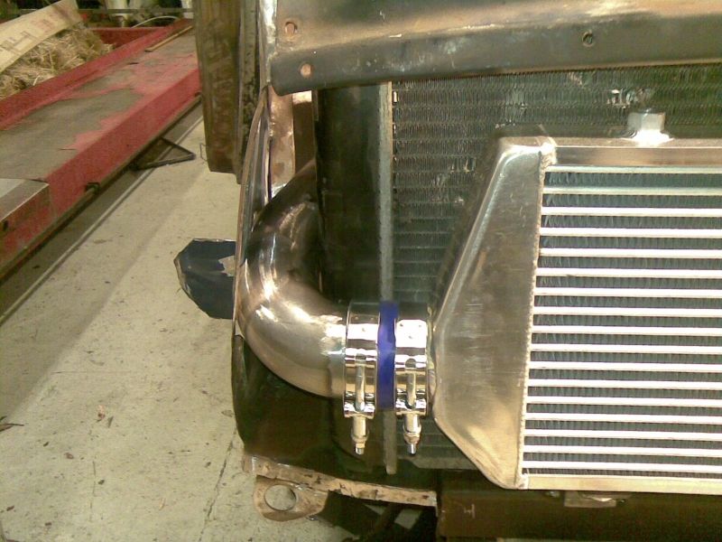 Intercooler piping connected to a radiator with blue clamps